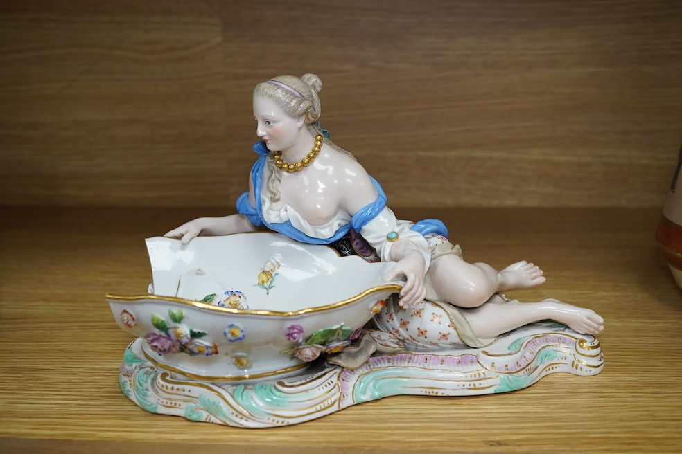 A Meissen female figural dish, 27cm wide. Condition - dish damaged (pieces in bag), crack near front knee